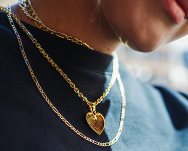 figaro chains, heart picture pendant, and a anchor cable chain  